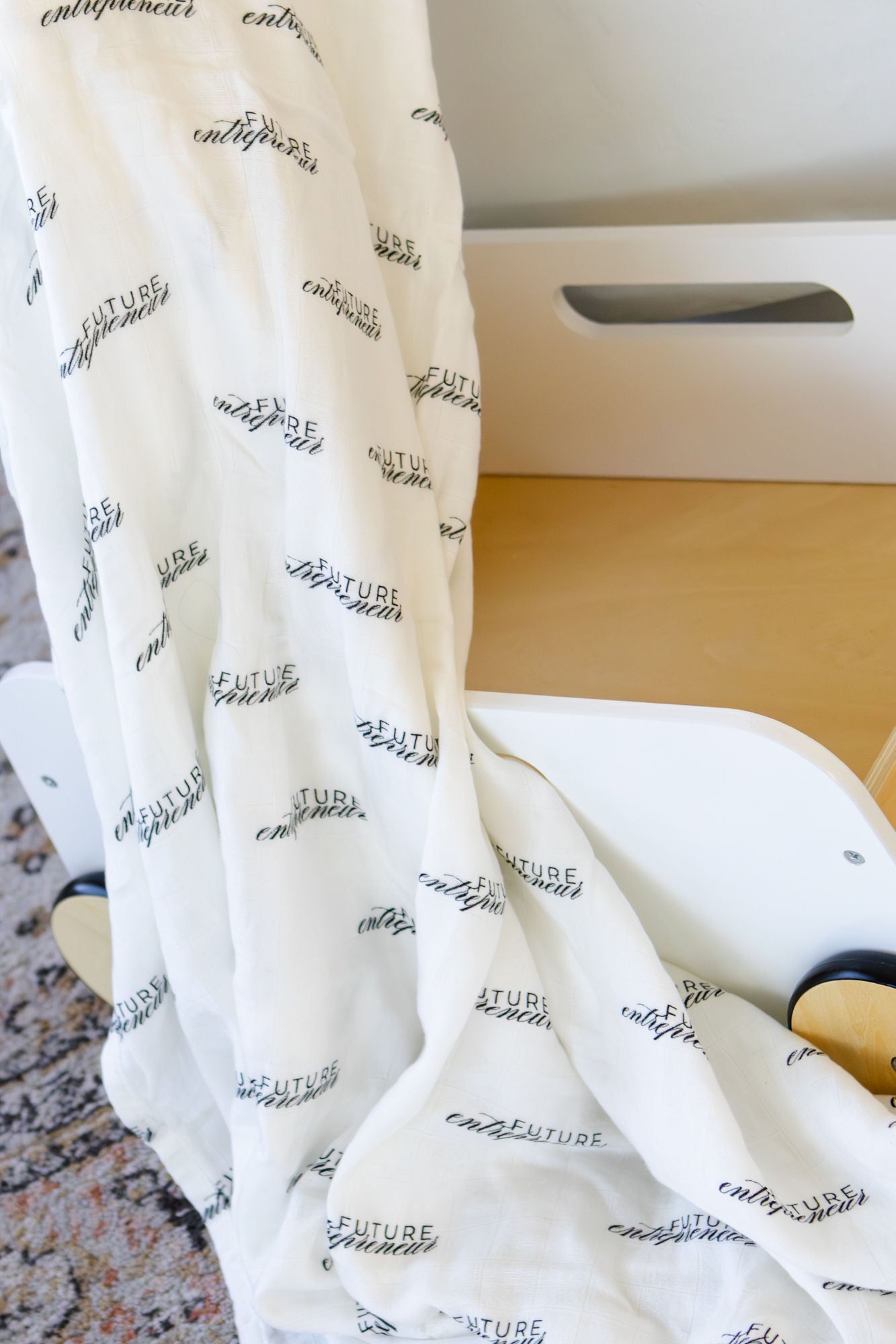 White blanket with text pattern draped over a surface